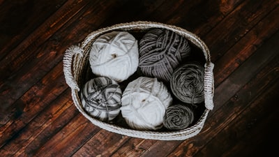 The white and brown yarn basket e
